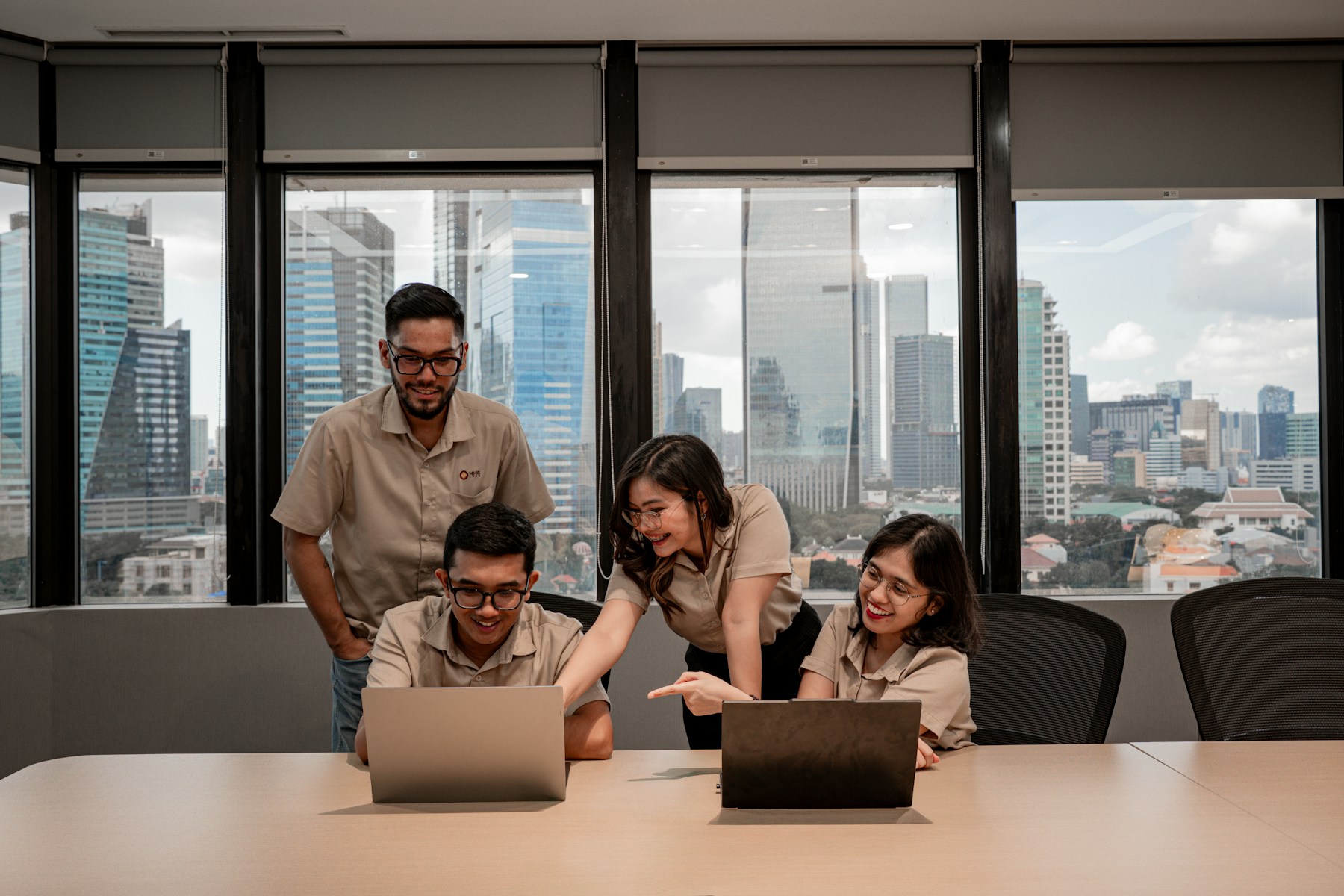 A real team collaborating around a laptop in a city office